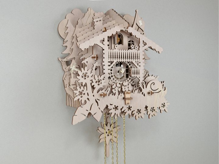 Swiss Koo – Koo Naturel: Bring a little piece of Switzerland into your home with this traditional-with-a-twist cuckoo clock. Entirely handmade in Switzerland from wooden slats, it captures the essence of the Alpine nation in its decor of a chalet, fir trees, a Swiss flag and countless whimsical details. Powered by a Regula mechanical movement with an eight-day power reserve, the Koo Naturel features a brass bell and a silent function for a quiet night. $