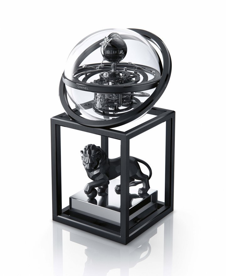 Chanel – Lion Astroclock: This remarkable timepiece is anchored by the symbols associated with the brand. The lion (Gabrielle Chanel was a Leo) is faceted to convey power and strength while black is, of course, a favourite colour of the maison. The base supports a glass sphere which contains a mechanical movement in all its splendour. Gravitating around it are a comet hand and a constellation-shaped hand set with diamonds, both in 18k white gold. A limited edition of five pieces. $$$