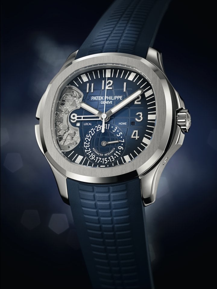 The Patek Philippe 5650G Advanced Research Aquanaut Travel Time White Gold, produced in a limited series in 2016, combines multiple innovations. It features a high-tech silicon regulating organ alongside a second innovation: a reset mechanism in which the usual pivoting joints are replaced by “compliant” or flexible components. This mechanism, comprising just 12 openworked steel parts, featuring a number of springs with interleaved blades (compared with the 37 components of a traditional mechanism), transmits information from the two GMT pushers to the local time display. 
