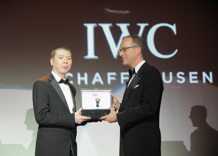 Chinese film director Feng Xiaogang is presented with the IWC Filmmaker Award by IWC Director of Marketing and Communications Goris Verburg