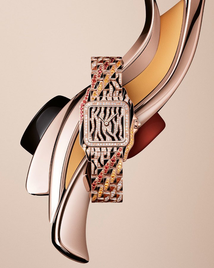 In keeping with its metamorphosis theme, Cartier imagines an abstract coat for its Panthère that is somewhere between tiger and zebra, in black and golden-brown lacquer, pavé-set diamonds, and orange and yellow spessartites.