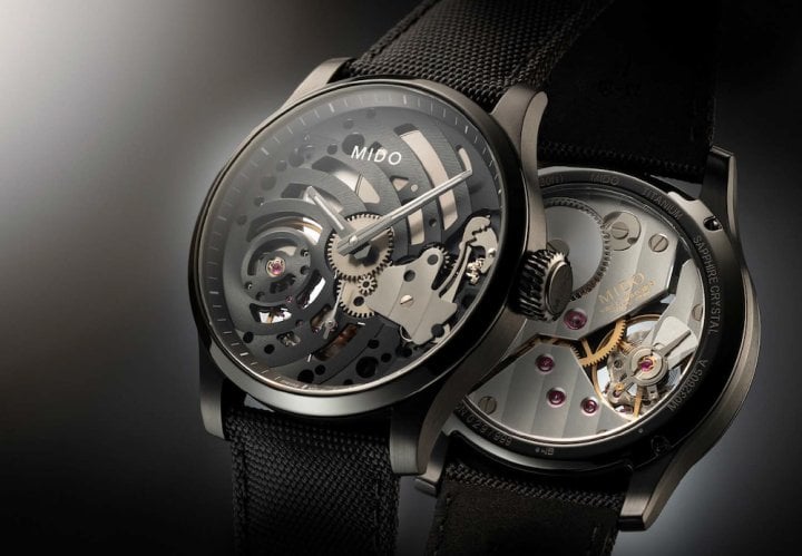 The dial-less Multifort Mechanical Skeleton Limited Edition, with a 44 mm diameter black PVD-treated titanium case, displays its skeleton movement (a first for Mido) with its hands integrated directly into the black plate decorated with Côtes de Genève. Limited series of 999 numbered pieces.