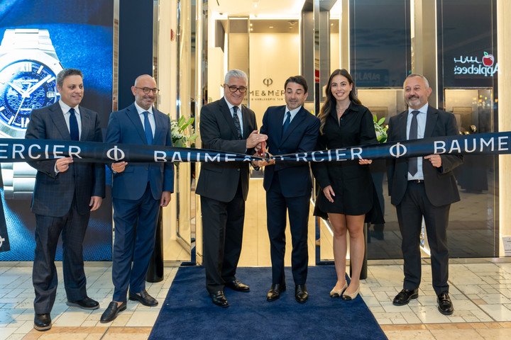 Michael Guenoun, Baume & Mercier CEO (centre), recently cut the ribbon at the brand's new store at Villaggio Mall in Doha, Qatar, with local partner Ali Bin Ali.