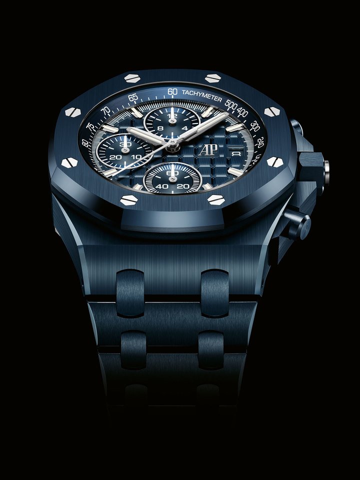 The 42 mm Royal Oak Offshore Selfwinding Chronograph presents a more sportive monochromatic aesthetic. Its ceramic components echo the “Bleu Nuit, Nuage 50” hue of the inner bezel, Méga Tapisserie dial and chronograph counters. The homogenous aesthetic is subtly contrasted by the eight hexagonal screws in stainless steel punctuating the bezel, as well as the titanium crown chip and caseback. 