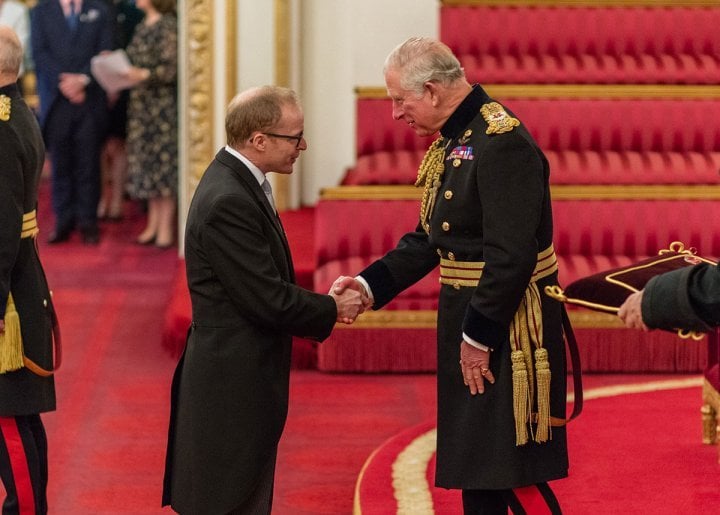 Roger W. Smith receiving his OBE from (then) Prince Charles