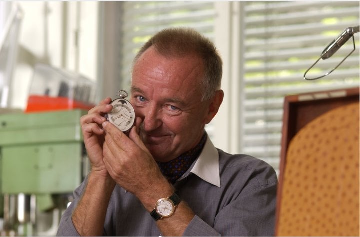 Peter Baumberger holding his favorite Urban Jürgensen watch, the 1991's oval tourbillon pocket watch, and wearing a Ref. 3.