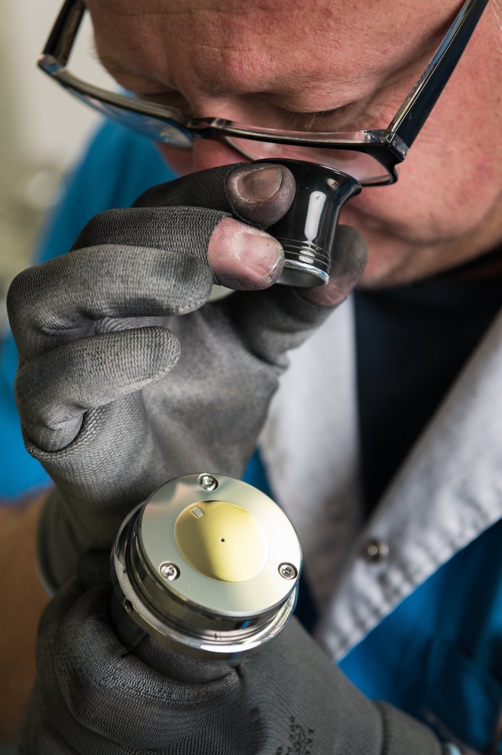 Inspecting the finish on a polished dial