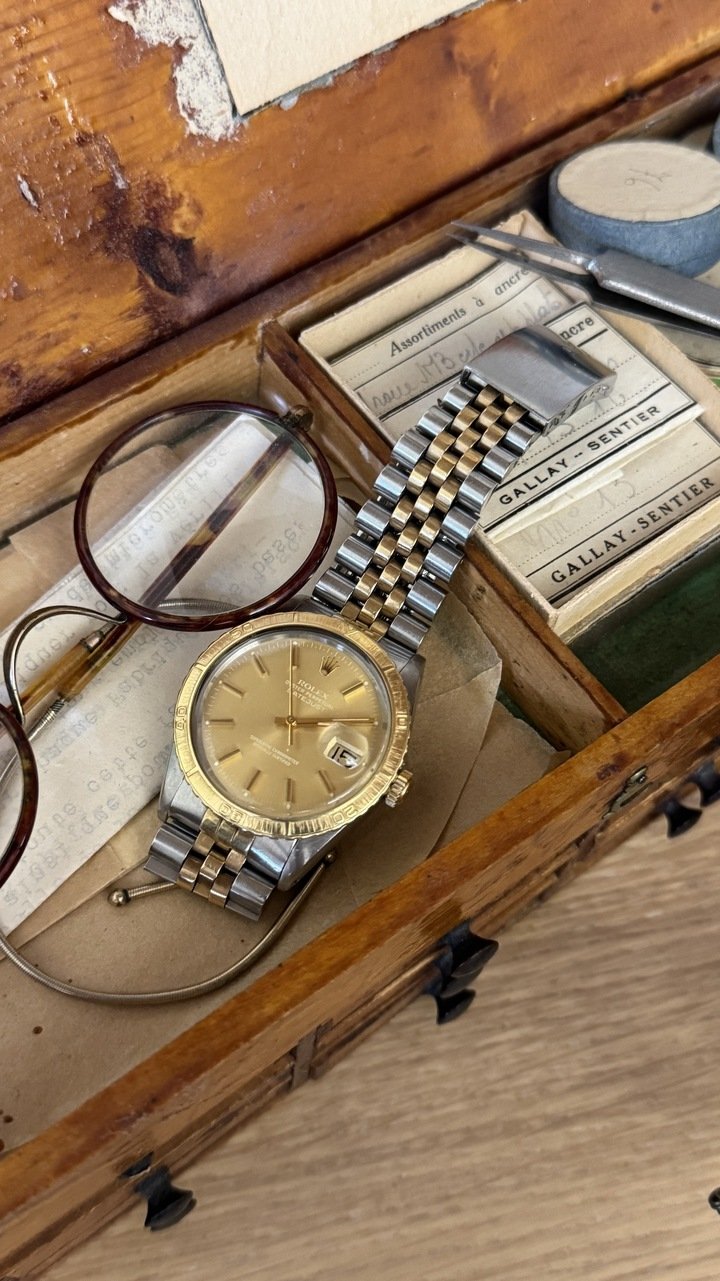 His grandfather's vintage Rolex on the watchmaker's cabinet he gifted to him and which once belonged to Albert F. Piguet.