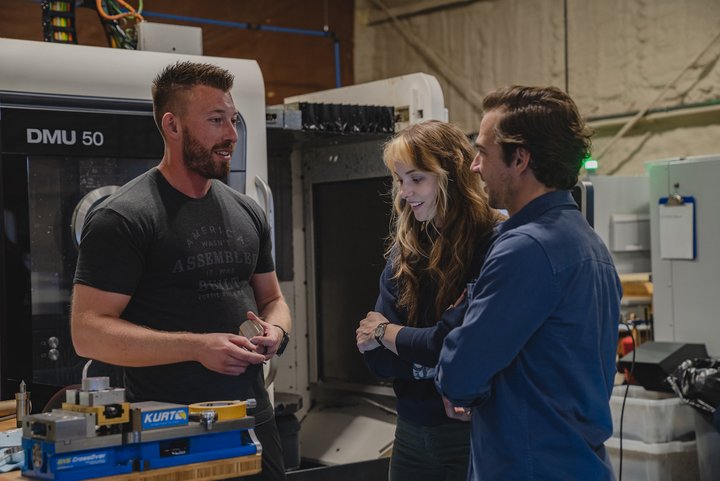 R.T. Custer (left) taking guests on a tour of the Vortic manufacturing facility.