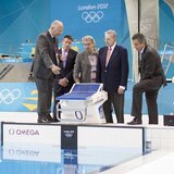 Omega Timing Chairman Peter Hürzeler, left, explains the swimming timing system to LOCOG Chairman Sebastian Coe, 2nd left, Swatch Group CEO Nick Hayek, 3rd left, International Olympic Committee President Jacques Rogge, 2nd right and Omega President Stephen Urquhart, right at the Aquatics Centre in London's Olympic Park 