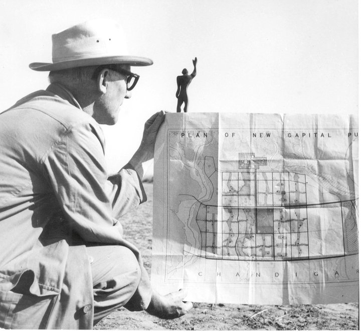Le Corbusier holding the plan of Chandigarh and the Modulor.