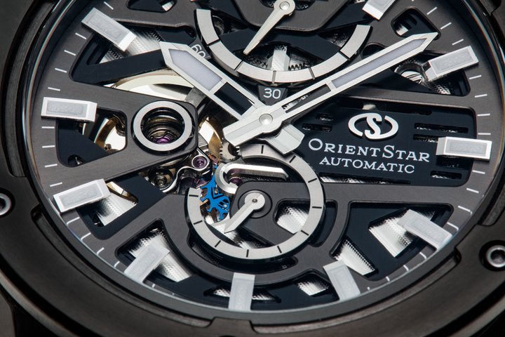 Calibre F8F64 with a silicon escapement and 60-hour power reserve, a first for an Orient Star self-winding movement. You can see the escapement, dyed blue, at 6 o'clock under the partly openworked base plate of the new Avant-Garde Skeleton. The two-layered dial design was carefully calculated make the transition between layers appear seamless. The seconds hands are arranged so as to stand out above the upper plate, giving an impression of depth and dimension to the distinctive skeleton structure. The SAR-coated sapphire crystal reduces light reflections by 99%, allowing all the facets of the design to be clearly visible. Case and bezel in stainless steel (SUS316L), brushed and mirror finishes achieved by Sallaz polishing.
