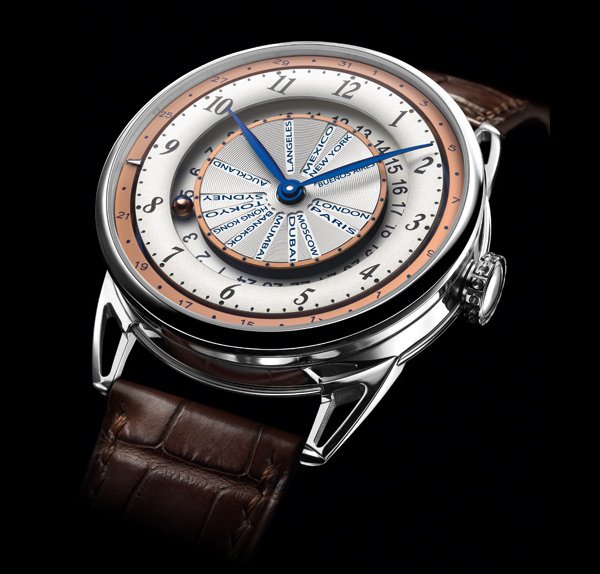 DB25 World Traveller by De Bethune: The different time zones, which radiate out from the centre of the dial, are set via a pusher at 8 o'clock, which advances the cities disc clockwise, one hour at a time. The time on the first 24-hour time zone, or reference time, is indicated by the mysterious ‘microsphere' which appears to float around its track. The sphere can be adjusted in both directions via the crown, and rotates at 6 a.m. and 6 p.m. to display either its front in rose gold, for daytime, or its back in blued steel, for night. Local time is indicated by blued hands. The date is read off the outermost disc by a jumping pointer, which is set by an adjuster at 10 o'clock.