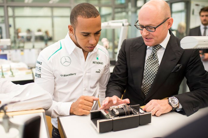Lewis Hamilton, brand ambassador and Mercedes AMG Petronas Formula One Team driver, center, with IWC CEO Georges Kern, right, during his visit to the headquarters of the Swiss luxury watch manufacturer in Schaffhausen, Switzerland