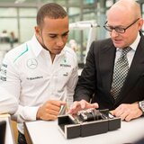 Lewis Hamilton, brand ambassador and Mercedes AMG Petronas Formula One Team driver, center, with IWC CEO Georges Kern, right, during his visit to the headquarters of the Swiss luxury watch manufacturer in Schaffhausen, Switzerland