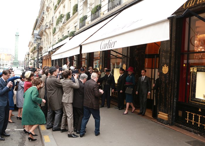 In this scene shot in front of the famous Cartier boutique at 13 rue de la Paix in Paris, she wears a reproduction of one of Princess Grace's favourite Caniche brooches by Cartier.