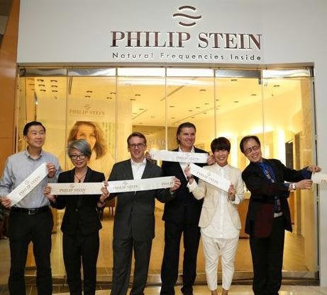 Will Stein, founder and president of the Philip Stein Group (third from right), celebrates the opening of the store with friends of the brand