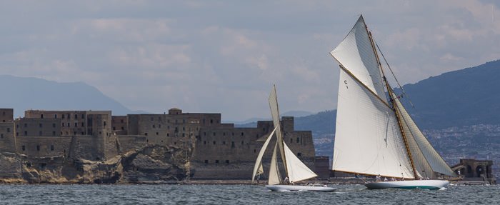 Classic yachts sailing across the harbour of Naples in the Vele d'Epoca