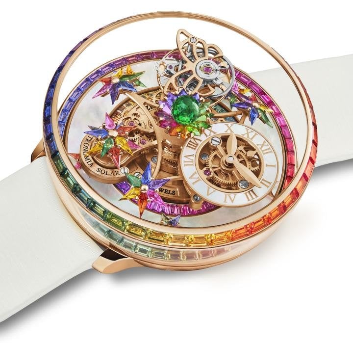 The 18K rose gold bezel of the Astronomia Fleurs de Jardin Rainbow is set with 40 rainbow sapphires, while the inner ring features 48 rainbow sapphires. Sitting on top of the movement is a green 288-facet Jacob-cut tsavorite. The frame carrying 11 flowers with kite-shaped multicoloured sapphires takes ten minutes to perform a complete rotation around the dial.