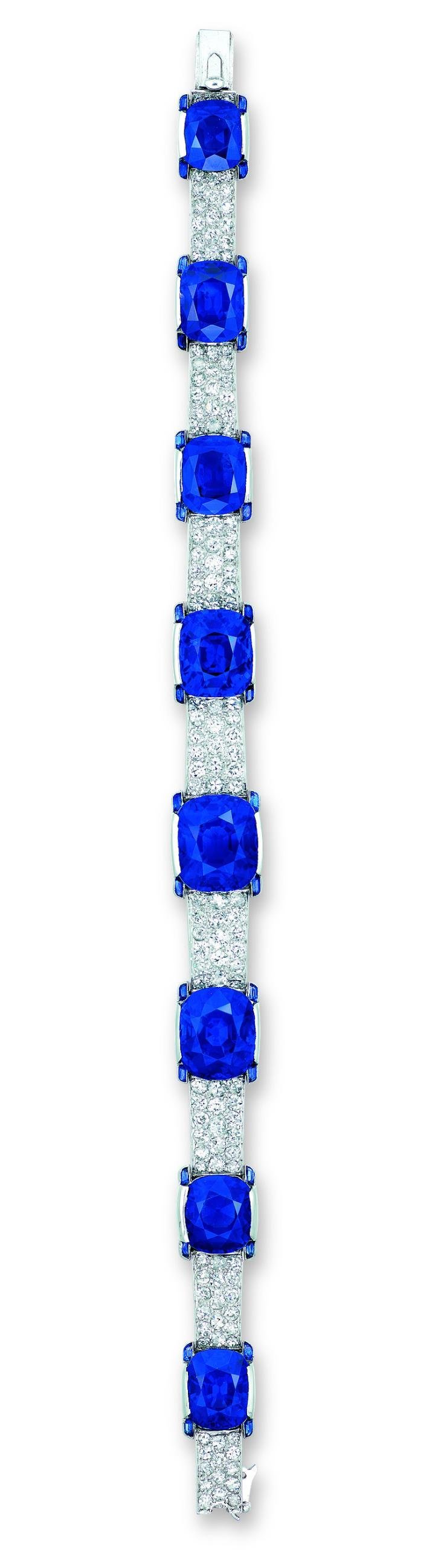  An exceptional Art Deco bracelet by Cartier sold by Christie's Hong Kong in 2016 for HKD 56,120,000 (USD 7,256,316) set with eight graduated cushion-shaped sapphires (10.53 to 3.38 car- ats) and four-stone diamond gallery, 1923, set in platinum.