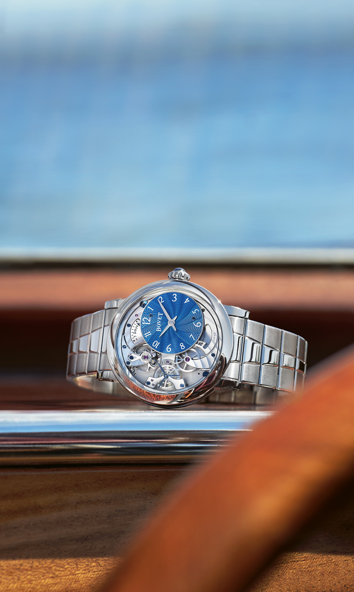 The off-set dial is made completely in-house, featuring Bovet's iconic “Lotus Flower” guilloche, with 12 petals to represent the 12 hours. The movement has been opened up to expose Bovet's in-house balance wheel and regulating organ, as well as a portion of the gear train providing the energy from the single barrel. A new bridge was developed for the seconds cage, adding to the mesmerizing visual effect. 
