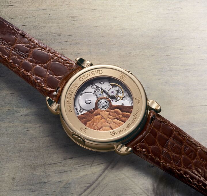 Andersen Genève marks its 45th anniversary with the Communication 45, a limited edition that celebrates the worldtimer's importance for the brand (top, shown next to the original from 1990). Since its creation, the worldtime module has been constantly refined and now measures just 0.9mm thick. Like the dial, the oscillating weight is 21k BlueGold in a cognac shade. The contrast with the frosted texture of the bridges and plates highlights the chamfering.