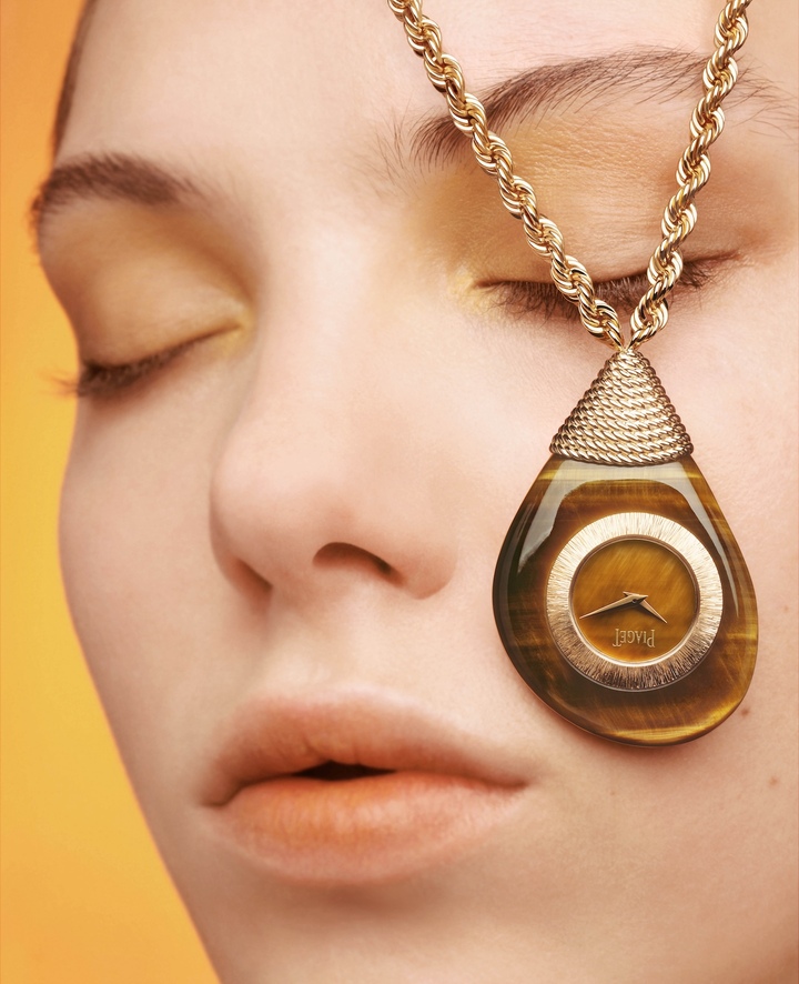 Piaget reinterprets its 1972 Kimono pocket watch as a trio of Swinging Pebbles sautoirs. Each sculptural timepiece, shaped as an asymmetrical pebble suspended from a twisted gold chain, is meticulously carved from a single ornamental stone – golden tiger's eye, grass-green verdite or pietersite. 
