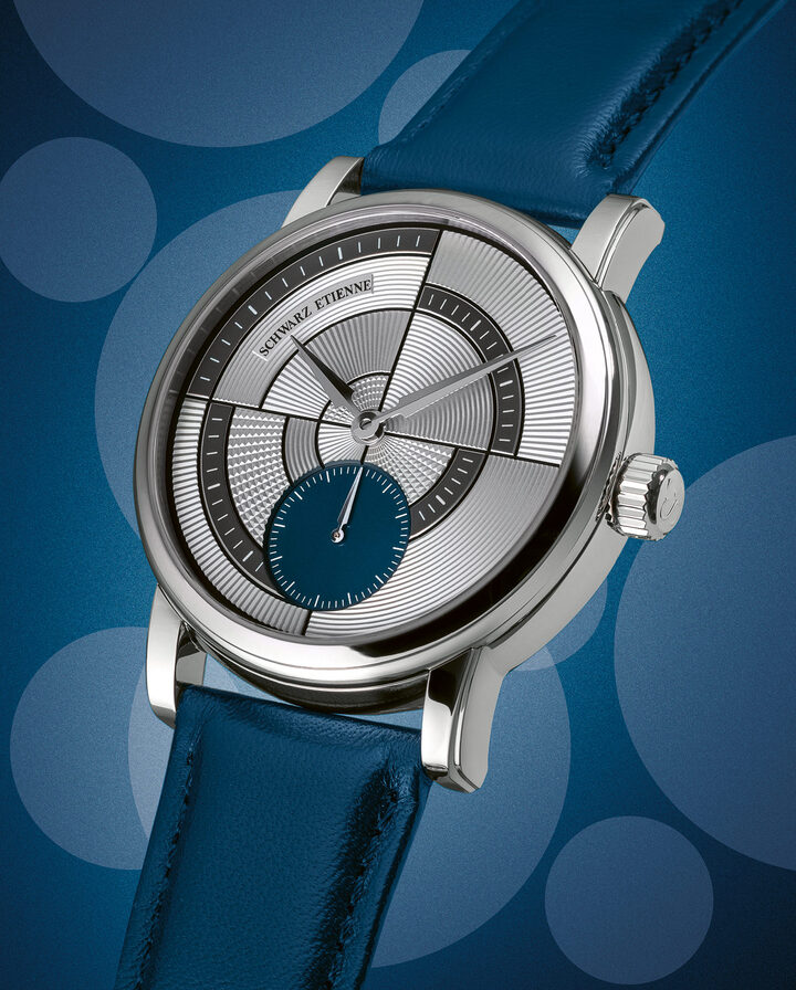 Lancine-style hour and minute hands float above a tapestry of intricately textured motifs, applied using hand-guilloché. A small seconds display, also with a lancine-style hand, is positioned at 6 o'clock. The dial, crafted from 18K gold, is offered in a choice of silver or salmon. 