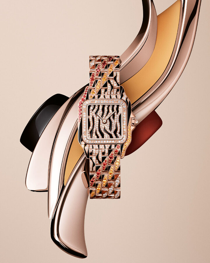 In keeping with its metamorphosis theme, Cartier imagines an abstract coat for its Panthère that is somewhere between tiger and zebra, in black and golden-brown lacquer, pavé-set diamonds, and orange and yellow spessartites.