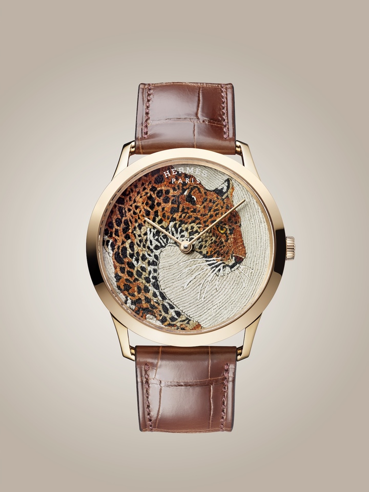 The Slim d'Hermès Panthère (2024) combines leather mosaic with leather-thread work. Both the whiskers and the dial background were created using finely applied leather threads, a technique developed by the Hermès leather atelier in Brügg.